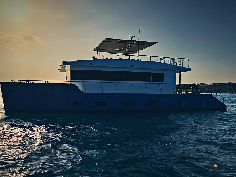 Qader Explorer catamaran in golden-hour light on the Red Sea